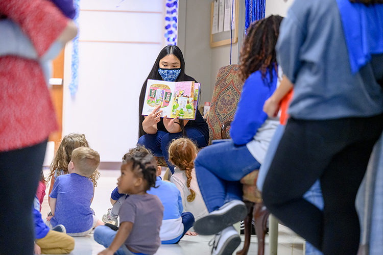 Phi Kappa Phi Student Vice President Maria Hite shows youngsters at the Child Development Center pictures from “Take Care, Good Knight” while reading the story to them. The book is part of the center’s new Little Free Library provided by the PKP and Omicron Delta Kappa honor societies at MTSU. (MTSU photo by J. Intintoli)