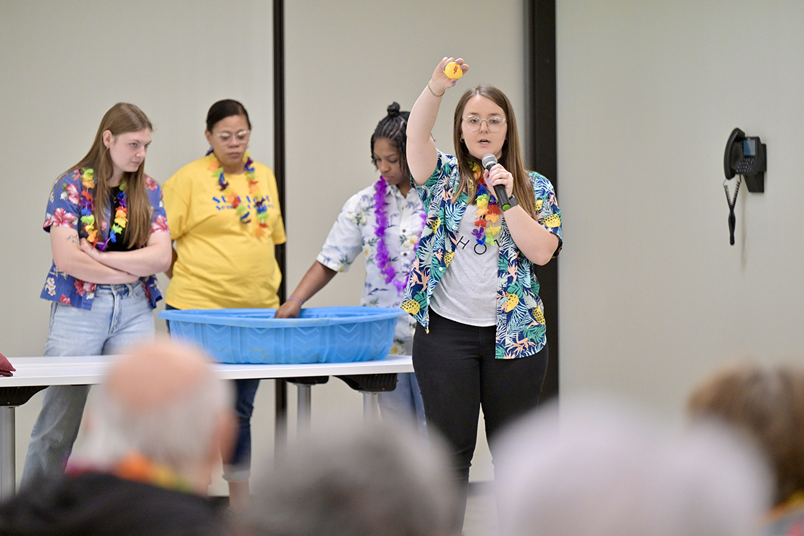 Middle Tennessee State University Aging Health and Development student Kylie Calvert explains a “match-the-duck” game to members of St. Clair Street Senior Center in Murfreesboro, Tenn., during a “cruise” party held as part of class on March 29, 2024. Each Friday during the semester, students in Human Development and Family Science lecturer Samantha Weir’s class plan and implement interactive games at St. Clair as well as Stones River Manor, in Murfreesboro, where MTSU is located. (MTSU photo by J. Intintoli)