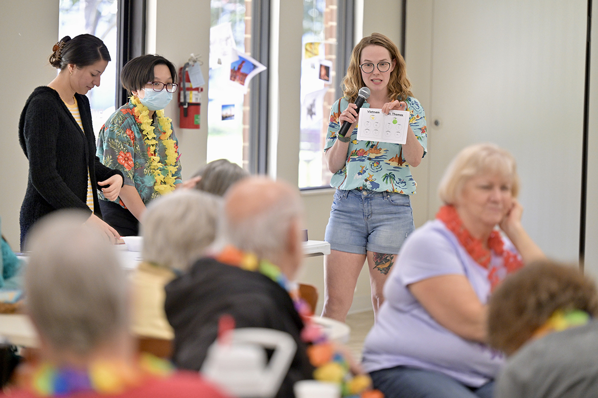 Fellow Middle Tennessee State University students Amy Rodriguez, left, and Vicki Nguyen assist student Tara Kirkpatrick, who is giving game instructions to members of St. Clair Street Senior Center in Murfreesboro, Tenn., during a “cruise” party held March 29, 2024, as part of a class assignment in the Aging Health and Development course taught by Human Development and Family Science lecturer Samantha Weir,. Each Friday during the semester, students in the course plan and implement interactive games at St. Clair as well as Stones River Manor, also in Murfreesboro where MTSU is located. (MTSU photo by J. Intintoli)