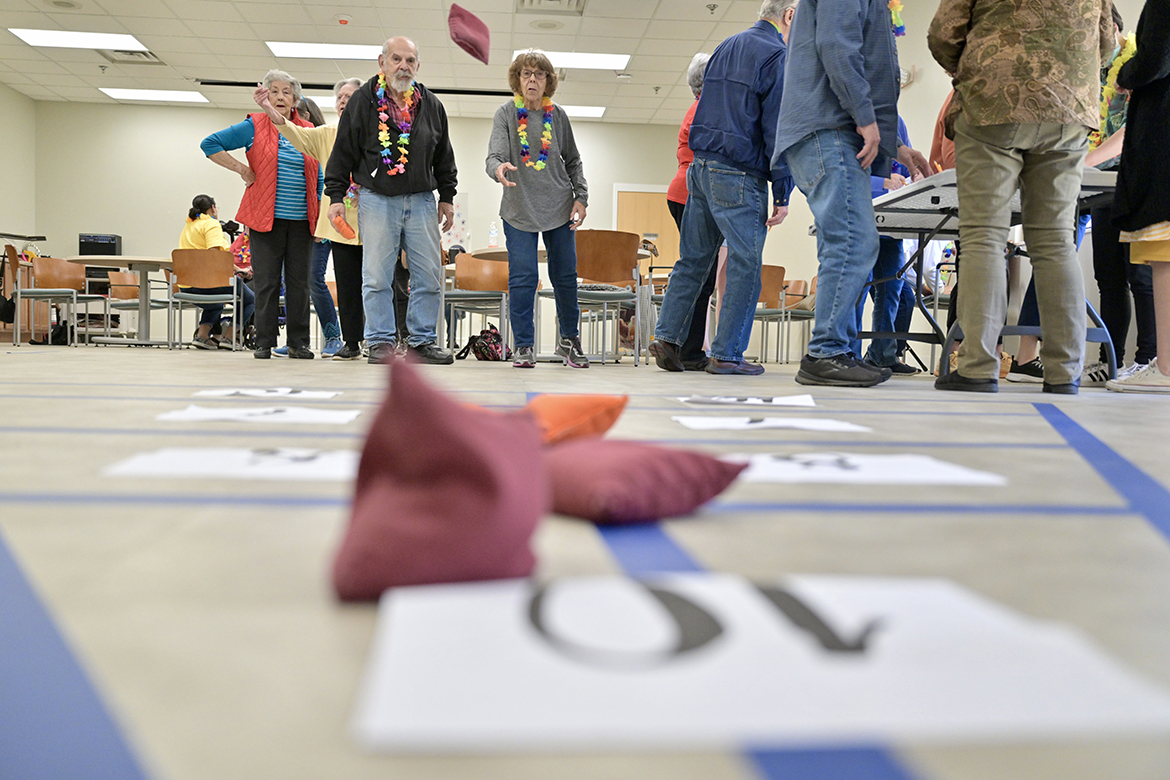 Members of St. Clair Street Senior Center in Murfreesboro, Tenn., play a shuffleboard-style game with bean bags as part of a “cruise” party hosted by Aging Health and Development students from the Department of Human Development and Family Science at Middle Tennessee State University in Murfreesboro. Each Friday during the semester, students plan and implement interactive games at St. Clair as well as Stones River Manor, also in Murfreesboro. (MTSU photo by J. Intintoli)