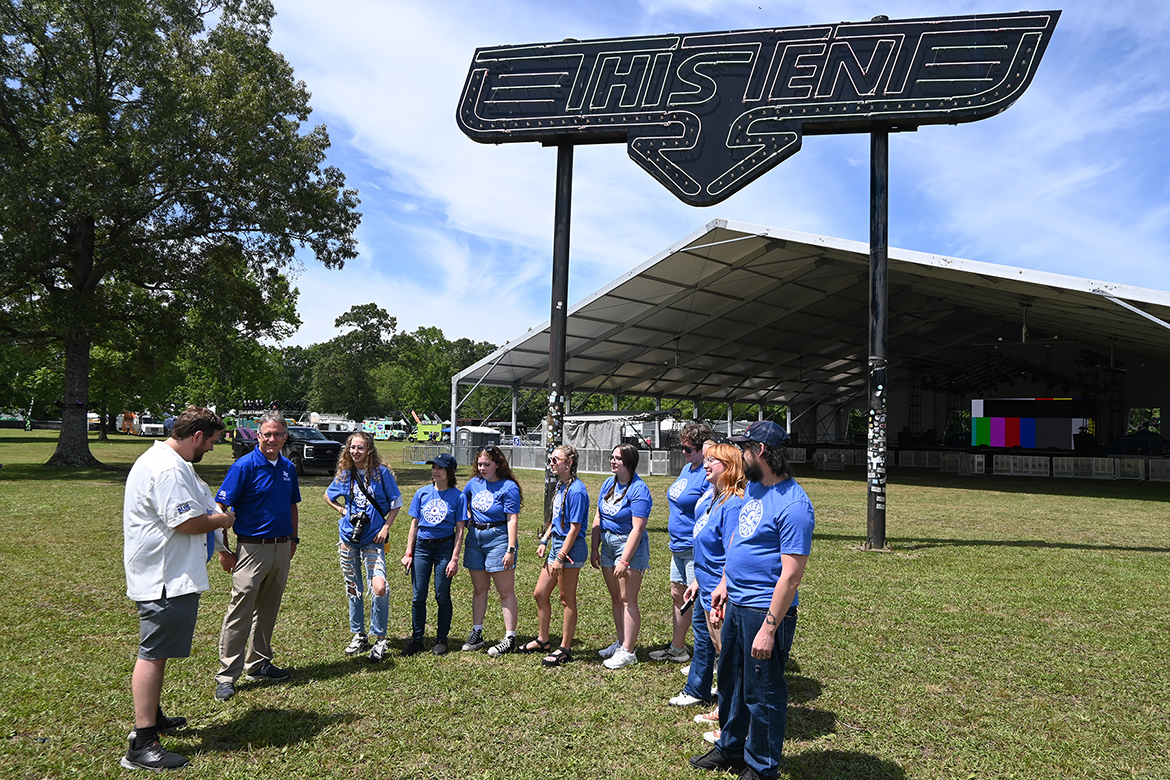 Matt Leimkuehler, left, adviser to MTSU’s Sidelines student media outlet, joins Middle Tennessee State University Provost Mark Byrnes, second from left, at Bonnaroo Music and Arts Festival’s This Tent stage Wednesday, June 12, in Manchester, Tenn., to talk with journalism students who will be covering the four-day event for news organizations across Tennessee. (MTSU photo by Andrew Oppmann)