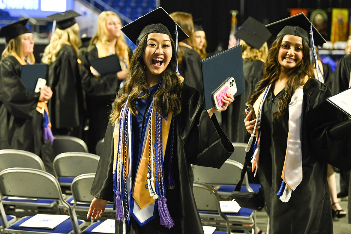 Two members of Middle Tennessee State University’s Class of 2023 smile after receiving their diplomas during morning commencement ceremonies held at Murphy Center. MTSU presented 1,761 undergrad and graduate degrees to students in two ceremonies held Dec. 16. (MTSU photo by Cat Curtis Murphy)
