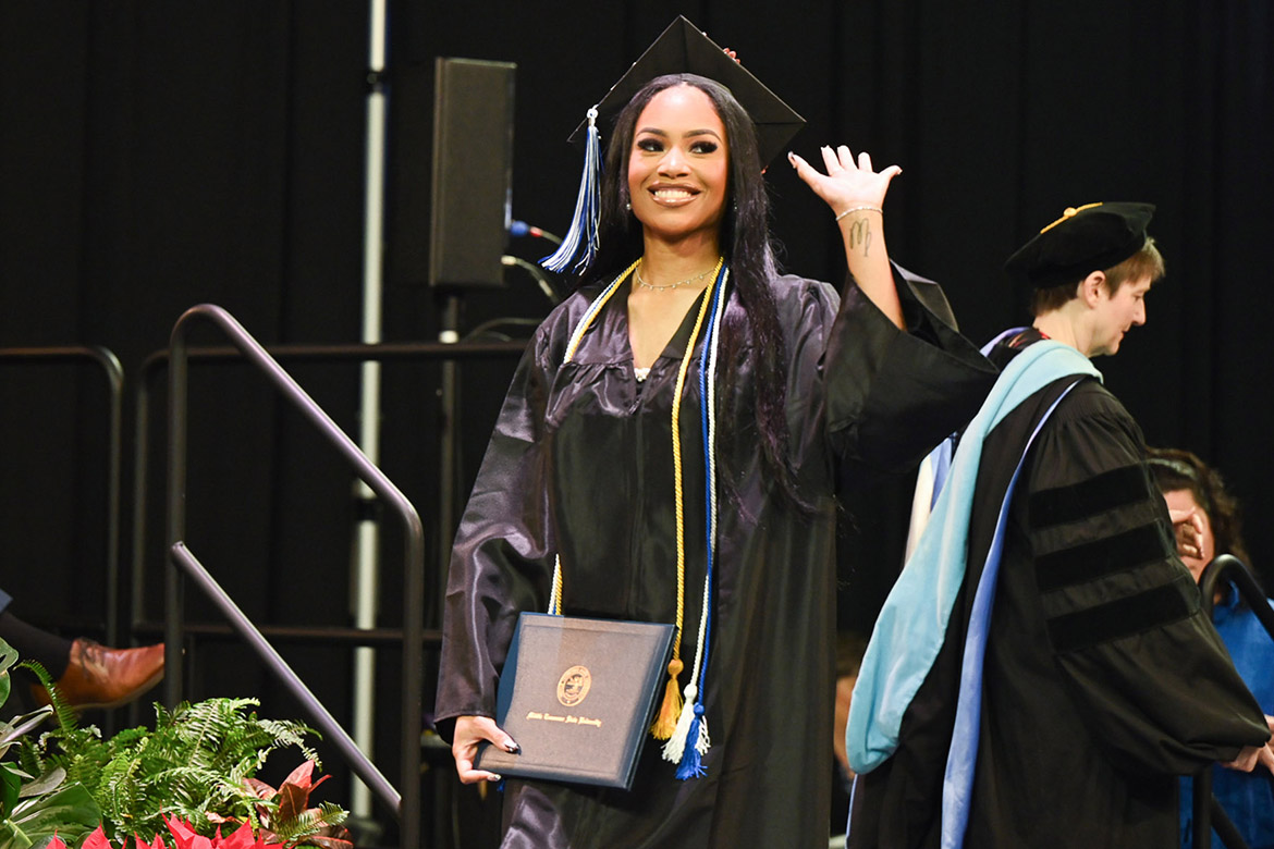 With diploma in hand, a member of Middle Tennessee State University’s Class of 2023 waves to friends and family at the morning commencement ceremony held Dec. 16 in Murphy Center. A total of 1,761 undergrad and graduate students garnered degrees during two ceremonies. (MTSU photo by Cat Curtis Murphy)