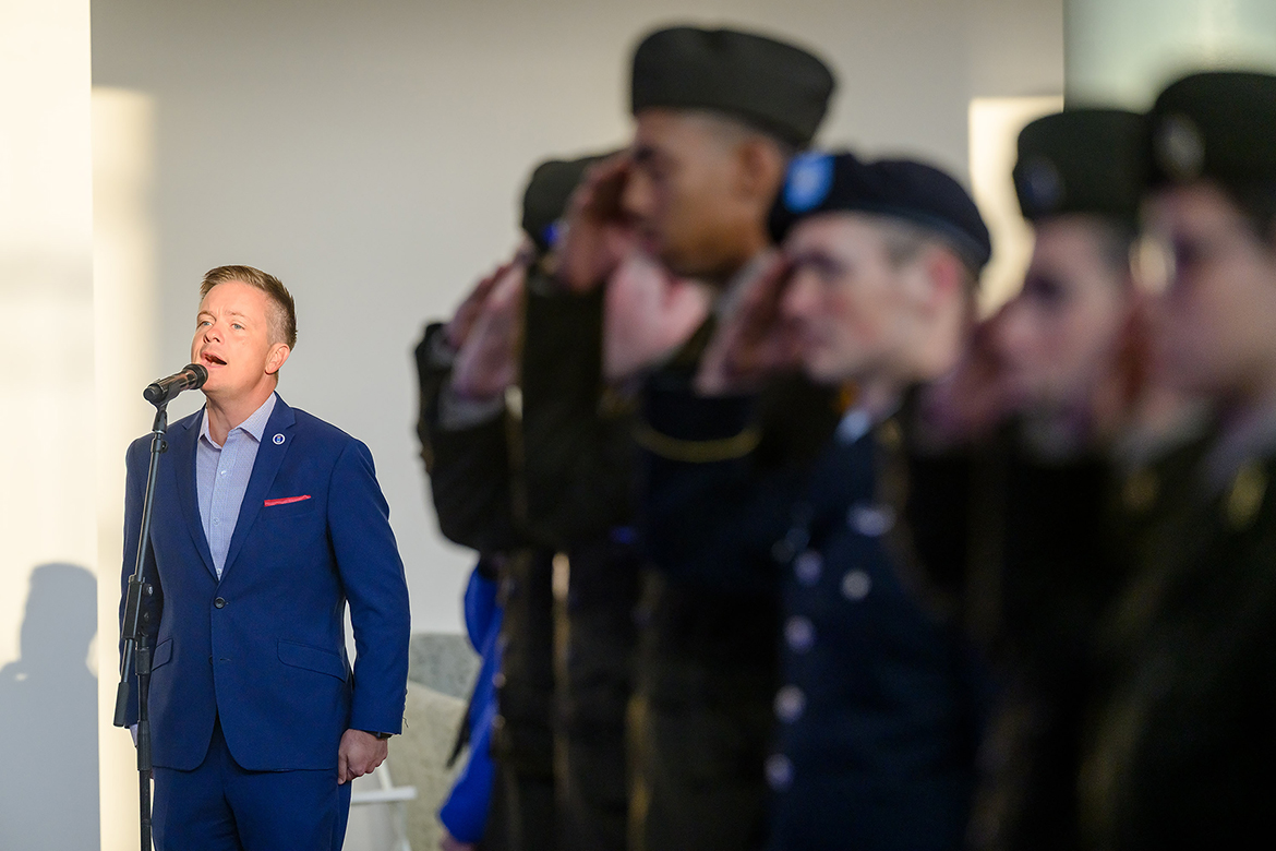 As nearby ROTC cadets salute, Jamie Teachenor, Middle Tennessee State University Recording Industry adjunct professor, performs the national anthem at the start of the 11th annual 9/11 Remembrance on Tuesday, Sept. 11, in the Miller Education Center on Bell Street in Murfreesboro, Tenn., on the 25th anniversary of the events surrounding the Sept. 11, 2011, series of attacks on U.S. landmarks by the terrorist group al-Qaida. (MTSU photo by J. Intintoli)
