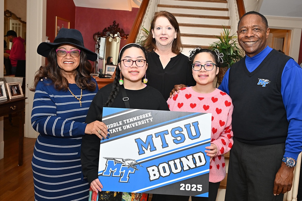 MTSU President Sidney A. McPhee, right, twins Maxine and BiBi Beasley and their mother, Beth Beasley, of Shelbyville, Tenn., hold the “MTSU Bound” yard sign they received while attending Admitted Student Day and a Celebration of Scholars visit to the President’s House Saturday, Feb. 22, on campus in Murfreesboro, Tenn. The twins plan to study graphic design in the College of Liberal Arts. (MTSU photo by James Cessna)