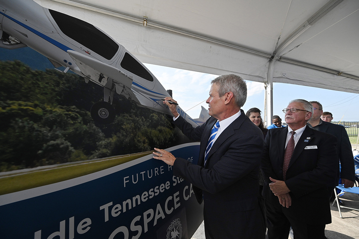 Tennessee Gov. Bill Lee signs his name to the under construction sign for the new Middle Tennessee State University Aerospace Campus to be built at the Shelbyville Municipal Airport in Bedford County, as Shelbyville Mayor Randy Cannon and others wait their turn Thursday, Sept. 21, following a special announcement event. (MTSU photo by J. Intintoli)