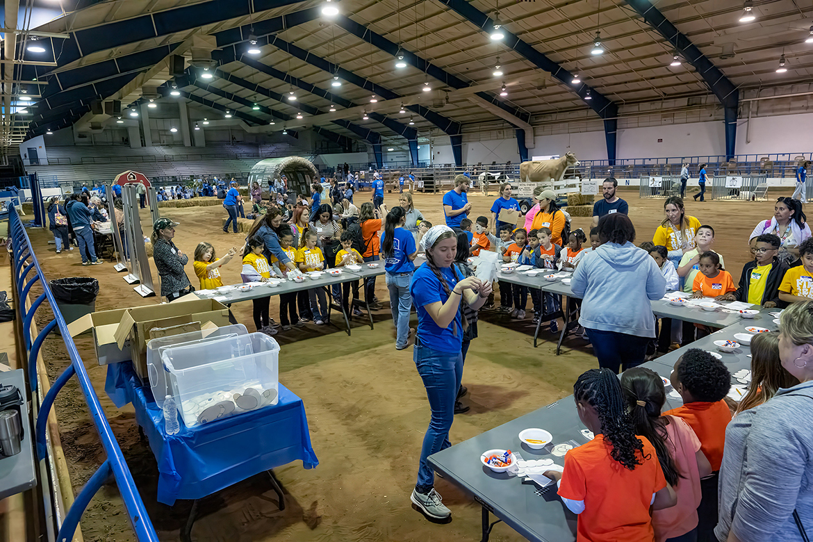 Volunteers help Murfreesboro schoolchildren work with a farm-related craft while attending the Middle Tennessee State University School of Agriculture Ag Ed Spring Fling in the Tennessee Livestock Center on the MTSU campus in Murfreesboro, Tenn., on Tuesday, April 15. (MTSU photo by Andy Heidt)