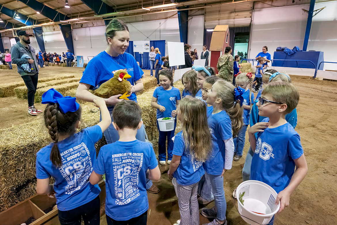 Murfreesboro schoolchildren from Campus School learn where eggs come from and about fruits and vegetables from a volunteer in the Little Acres area during the annual School of Agriculture Ag Ed Spring Fling on Tuesday, April 15, held in the Tennessee Livestock Center on the Middle Tennessee State University campus in Murfreesboro, Tenn. (MTSU photo by Andy Heidt)