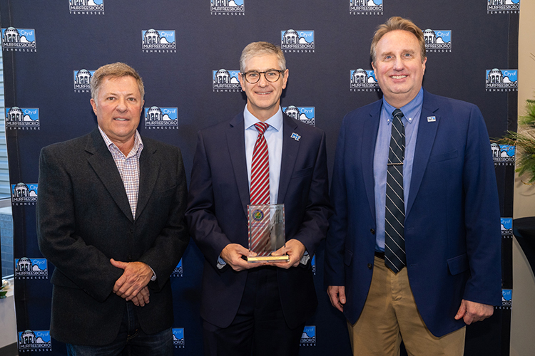 Greg Van Patten, center, dean of Middle Tennessee State University’s College of Basic and Applied Sciences, holds the Federal Aviation Administration safety award presented to Murfreesboro Municipal Airport during a special ceremony Thursday, Dec. 14, at the airport. Pictured, from left, are Steve Waldron, chair of the Murfreesboro Airport Commission; Van Patten; and Murfreesboro Airport Director Chad Gehrke. (MTSU photo by James Cessna)