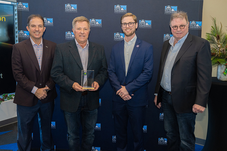 Murfreesboro Municipal Airport receives a Federal Aviation Administration safety award during a special ceremony Thursday, Dec. 14, at the airport. Pictured, from left, are Murfreesboro Mayor Shane McFarland; Steve Waldron, chair of the Murfreesboro Airport Commission; John Saalwaechter, director of the Tennessee Department of Transportation’s Aeronautics Division; and Bob Hill of the FAA. (MTSU photo by James Cessna)