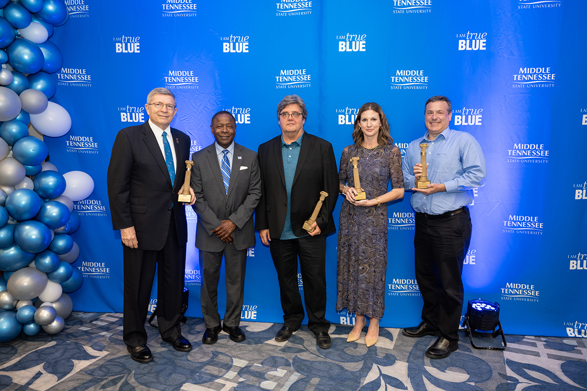 Middle Tennessee State University President Sidney A. McPhee, second from left helps recognized MTSU Alumni Award Citations of Distinction honorees Rickey Smith, left, William “Bill” Campbell (Achievement in Education MTSU faculty), Lauren Rhae (Achievement in Education (non-MTSU faculty) and Christian Ketel (Service to Community) Friday, Sept. 22, in the MT Center in the Ingram Building. Distinguished Alumnus William “Bill” Phillips and Young Alumni Achievement recipient Justin Hart were unable to attend. (MTSU photo by James Cessna)