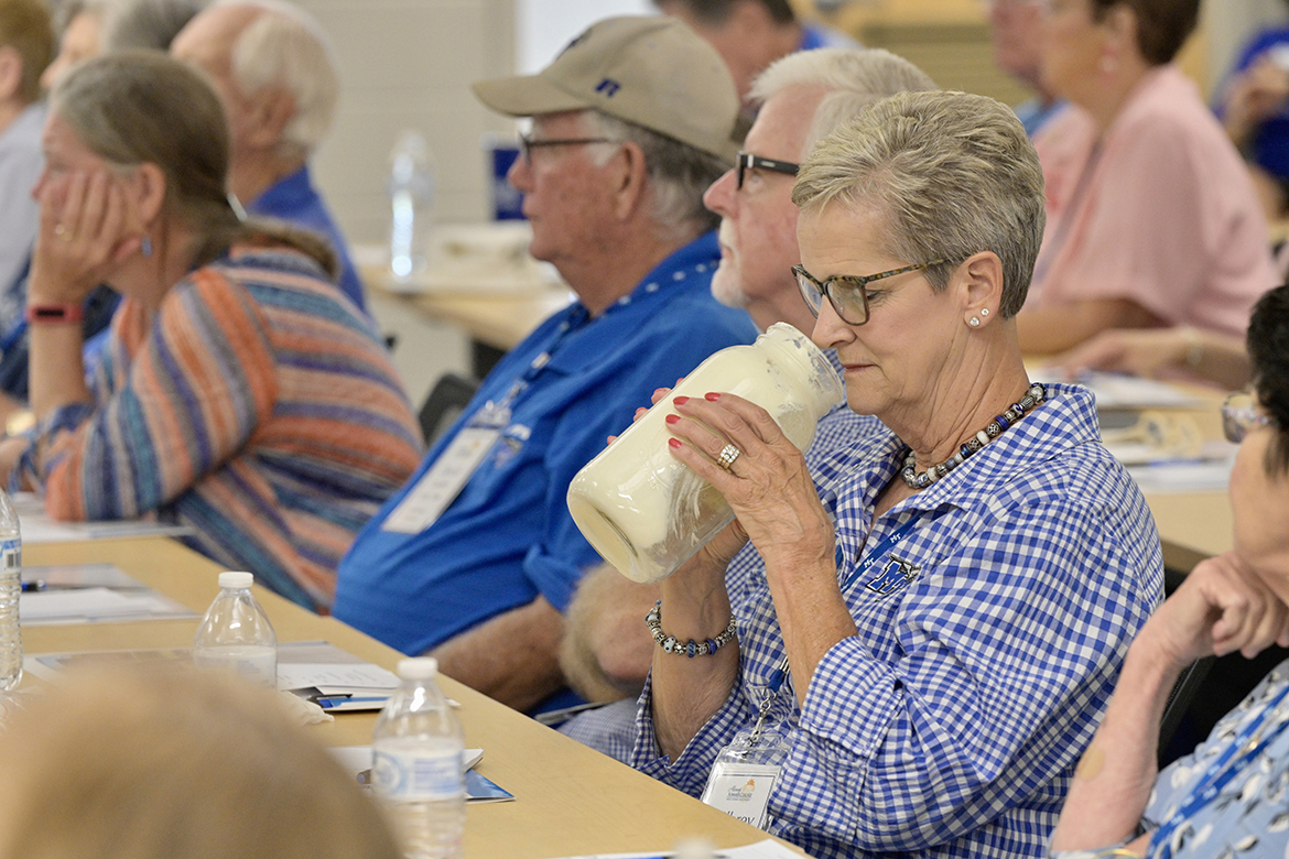 MTSU alumna Milbrey Campbell views the contents inside the jar being passed around during a fermentation science presentation about yogurt in a Davis Science Building classroom at this year’s Alumni Summer College. Attendees learned about the fermentation process for meats, cheeses, dairy and alcoholic  beverages. (MTSU photo by Andy Heidt)