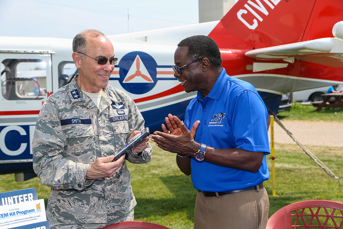 Maj. Gen. Mark Smith, left, Civil Air Patrol’s national commander and chief executive officer, presents Middle Tennessee State University President Sidney A. McPhee with a plaque Monday, July 26, recognizing the university as CAP’s Tennessee Wing’s top aerospace education partner in 2020. COVID-19 precautions prevented CAP from presenting the honor in person last year. MTSU and Civil Air Patrol renewed their partnership Monday at EAA AirVenture 2021 in Oshkosh, Wisc., just hours after the Experimental Aircraft Association’s signature annual event roared back after a one-year COVID-19 hiatus. (U.S. Air Force Auxiliary photo by Lt. Col. Robert Bowden)