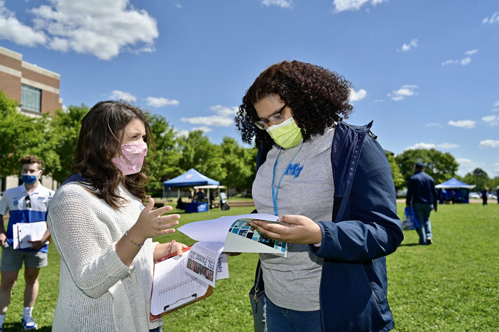 MTSU junior speech pathology major Maddie Vernon, left, of Trenton, Tenn., explains the Fraternity and Sorority Life options to Marjaleona Mossett of Nashville, Tenn., recently during the special CUSTOMS orientation Yard Party at the Student Union Commons. More than 4,000 combined freshmen and transfer students will attend this summer. (MTSU photo by Andy Heidt)