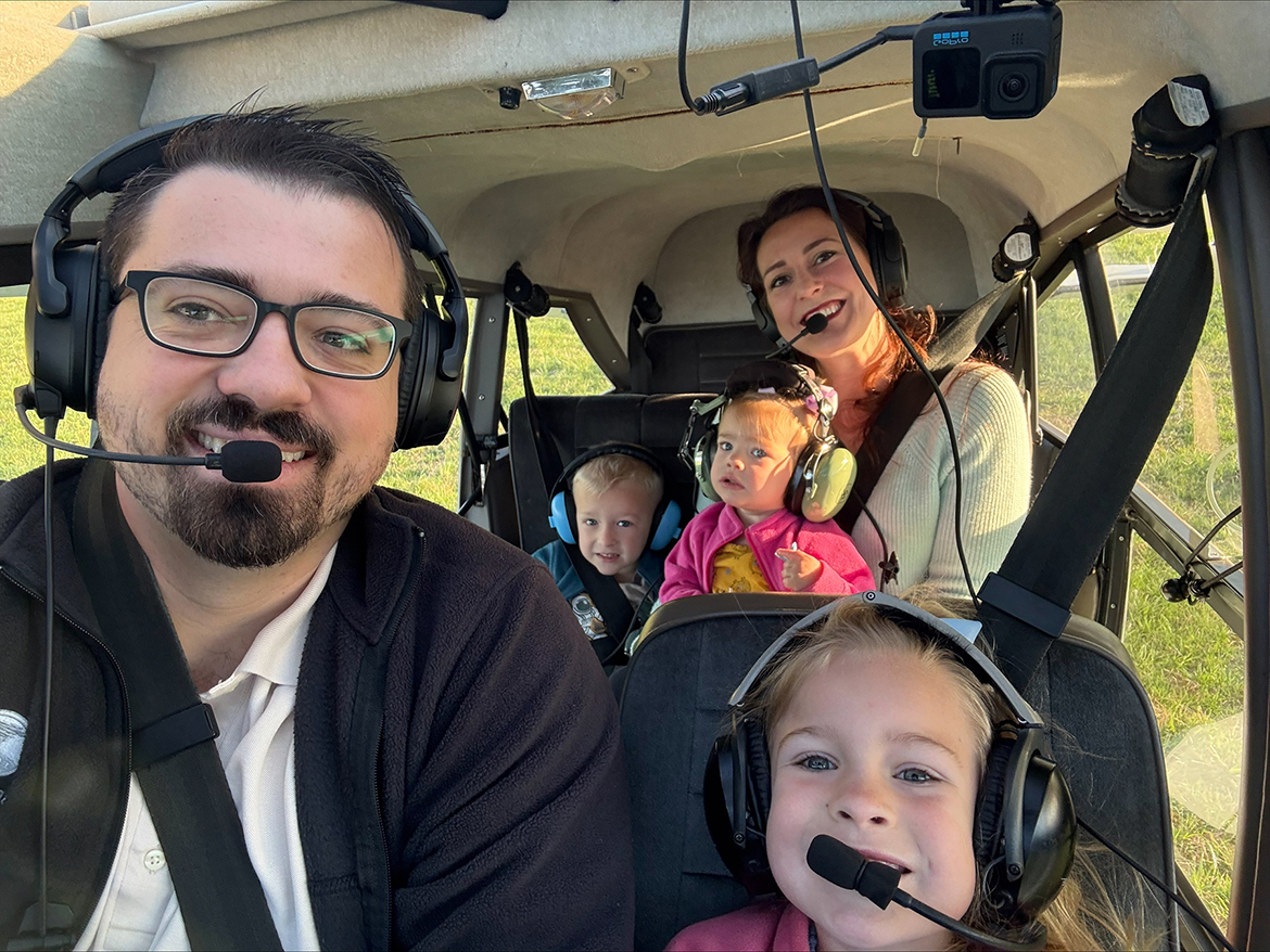 Middle Tennessee State University Aerospace Department professor Collin McDonald, left, is shown with his family while seated in a small private aircraft. McDonald recently received the $5,000 King Schools/National Association of Flight Instructors Flight Scholarship at Sun ’n Fun Expo in Lakeland, Fla., on April. 2. (Submitted photo)