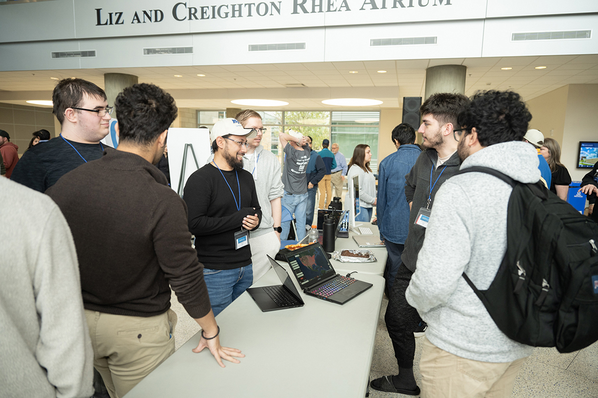 Team members discuss their school search/college finder project during the ninth annual Middle Tennessee State University Computer Science HackMT in the MTSU Science Building on Sunday, Jan. 28. Ten teams participated in the 36-hour hackathon. (MTSU photo by James Cessna)