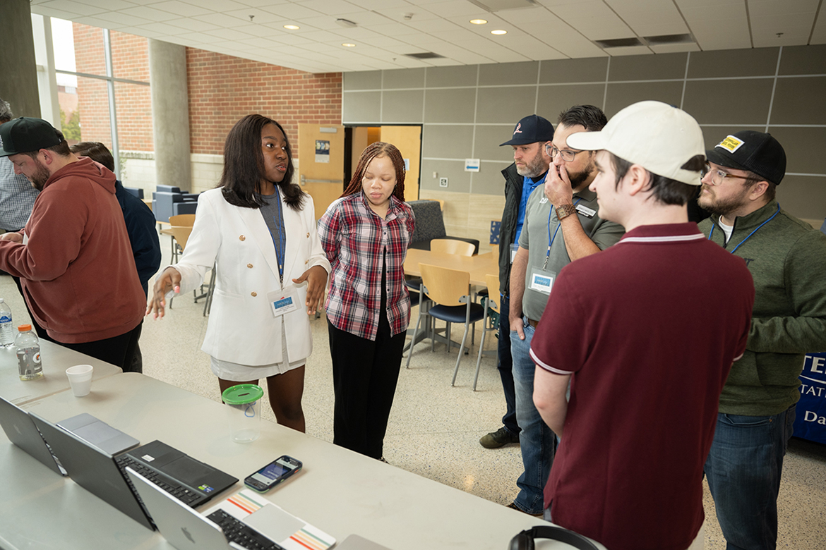 A Middle Tennessee State University Computer Science student explains her team’s project to representatives from HackMT sponsor CAT Financial Sunday, Jan. 28, in the MTSU Science Building. The 36-hour event brought tech savvy students together to collaborate on projects. (MTSU photo by James Cessna)
