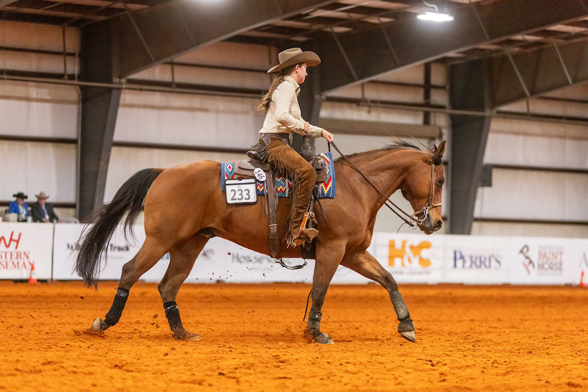 Riding a horse named Gunador, provided by Murfreesboro, Tenn.-based Team Need A Hand, Middle Tennessee State University rider Jordan Martin won the Back on Track USA-sponsored Western High Point class during the competition held May 3-5 at Tryon International in Mill Spring, N.C. Aboard a horse named Robin, provided by St. Andrews University in North Carolina, Martin won the American Paint Horse Association-sponsored Horse and Rider Team Open Horsemanship. (Photo by Hannah Foreman)