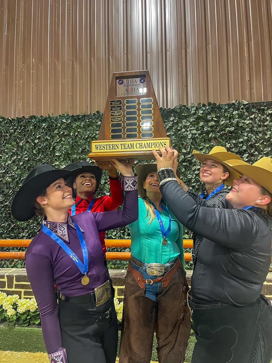 Middle Tennessee State University Western team members, from left, Simone Allen, Sadio Barnes, Mackenzie Latimer, Jordan Martin and Monica Braunwalder lift the Intercollegiate Horse Show Association national championship trophy earned for the second consecutive year. This year’s competition was held May 3-5 at Tryon International in Mill Spring, N.C., and was an outstanding team and individual effort by the Blue Raider riders. (MTSU photo by Andrea Rego)