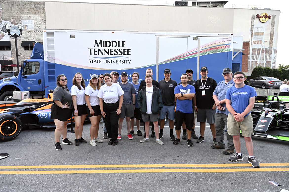 Led by professor, executive producer and director Robert “Bob” Gordon, second from right, and Nathan Wallach of MT Athletics, Middle Tennessee State University Media Arts Productions students manned cameras, ran video packages, produced audio for both a broadcast and public address system, built a stage and more Thursday, Aug. 3, on Lower Broadway in downtown Nashville, Tenn., for an NTT IndyCar Series/Big Machine Music City Grand Prix news conference. They were prepared to do a live broadcast of a pit road competition, canceled because of weather. (MTSU photo by James Cessna)