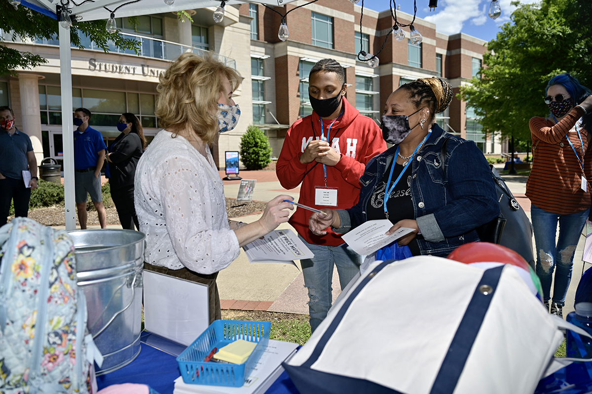 MTSU Phillips Bookstore Manager Natalie Karousatos, left, provides information about the store located inside the Student Union to Micah Davis of Knoxville, Tenn., and his mother, Laronda Turman during their May 13 CUSTOMS orientation visit to campus. They and others attended a Yard Party to learn more about campus departments and student organizations. Orientation will be held for new freshmen and transfers until the first week in August. (MTSU photo by Andy Heidt)