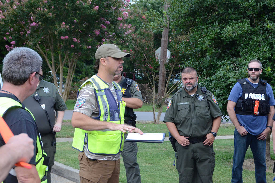 MTSU Police Capt. Jeff Martinez, center left, debriefs a group of about 30 emergency responders from throughout Rutherford County following a training session scenario at MTSU held in early August as part of a comprehensive course to train more than 1,200 emergency responders on better coordination across the county by the end of the year. Martinez is among the instructors teaching the courses. (MTSU photo by Jimmy Hart)