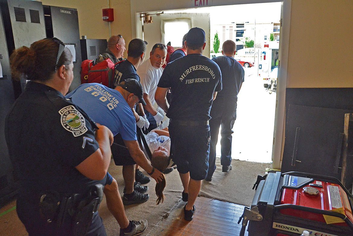 Emergency responders representing a variety of Rutherford County agencies work together to extract a “victim” play-actor to an awaiting ambulance as part of a training scenario held in early August inside MTSU’s College Heights Building. The training is part of a comprehensive program that began in the spring to train more than 1,200 emergency responders across the county by the end of the year. (MTSU photo by Jimmy Hart)