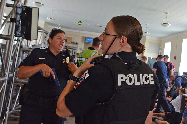 MTSU Police Officer Katelyn Adams, foreground, gives radio instructions as part of a training session scenario held in early August inside MTSU’s College Heights Building as part of a comprehensive course to train more than 1,200 emergency responders across the county by the end of the year. Adams was the designated “room boss” in the scenario, meaning the scene was under her command. (MTSU photo by Jimmy Hart)
