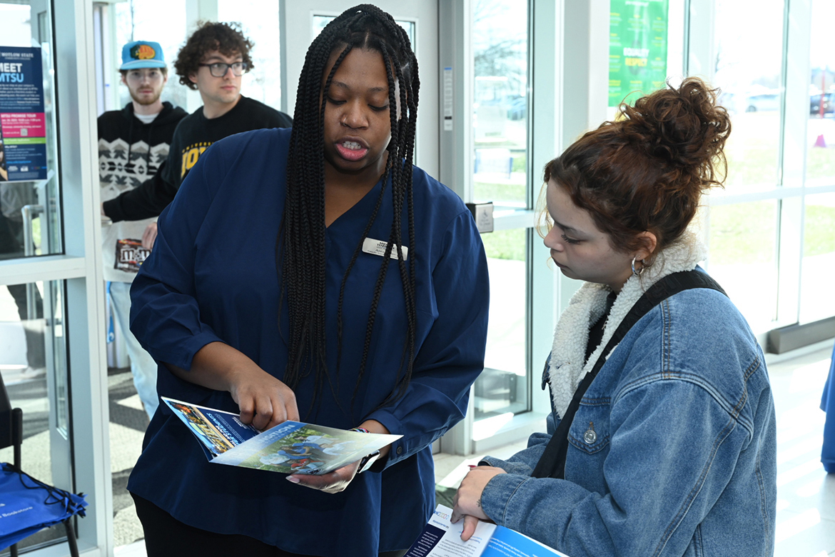 Anna Goins, left, Middle Tennessee State University enrollment coordinator in  undergraduate recruitment, assists a Motlow State Community College student attending the kickoff to the 2023 MTSU Promise Tour Tuesday, Jan. 24, in Smyrna, Tenn. MTSU will take the tour to recruit transfer students to Nashville State Community College on Thursday, Jan. 26. The event is scheduled from 10 a.m. to 1 p.m. (MTSU photo by James Cessna)