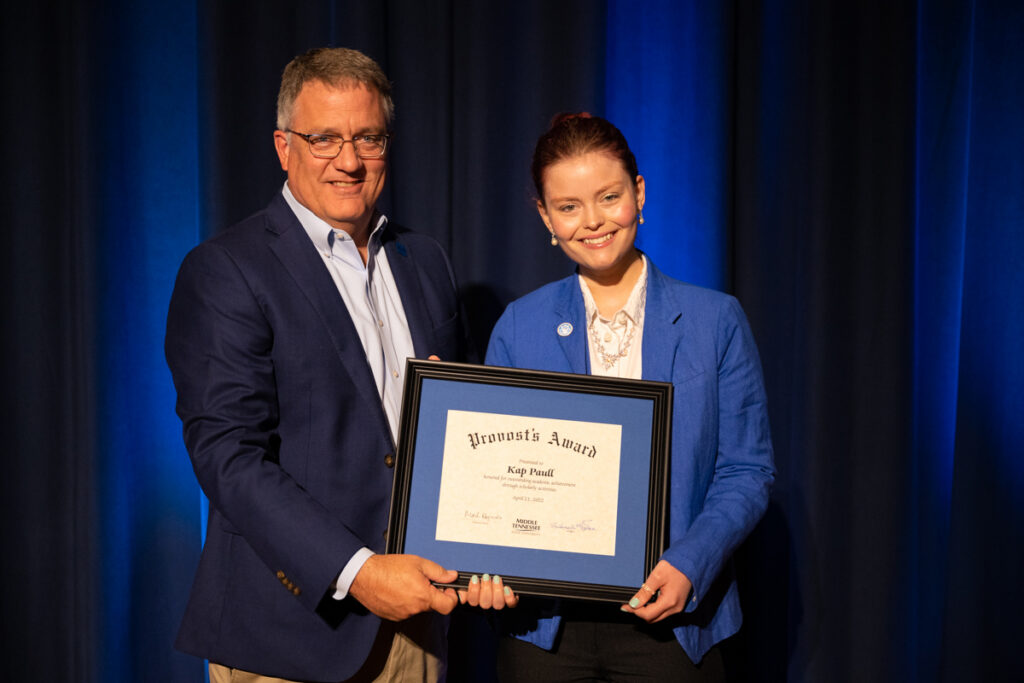 MTSU Provost Mark Byrnes, left, presents the annual Provost's Award for 2021-22 to Kap Paull of Knoxville, Tenn., recently during the College of Basic and Applied Sciences Awards in the James Union Building's Tennessee Room. (MTSU photo by James Cessna)