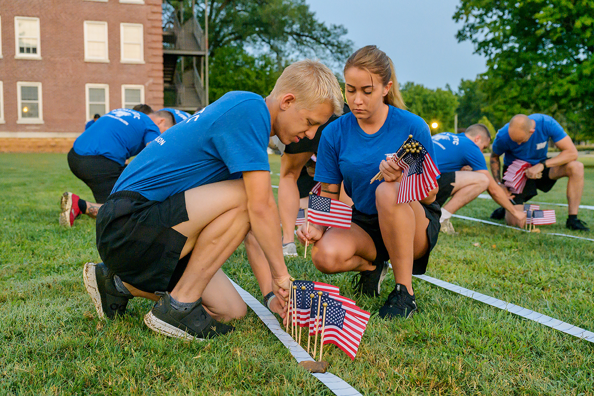 MTSU ROTC cadets Ethan Hawks and Aiyanna Gallant plant U.S. flags in a grassy area outside the Veterans Memorial and Tom H. Jackson Building at 6 a.m. Friday, Sept. 10, to help commemorate the 20th anniversary of 9/11. Sixty cadets, student veterans, SGA members and military science faculty took part at this location and in Floyd Stadium. Nearly 3,000 flags and 2,977 names of victims who died in the Sept. 11, 2001, attack on U.S. soil during a series of four coordinated terrorist suicide attacks by the extremist group al-Qaida on U.S. landmarks. (MTSU photo by Andy Heidt)