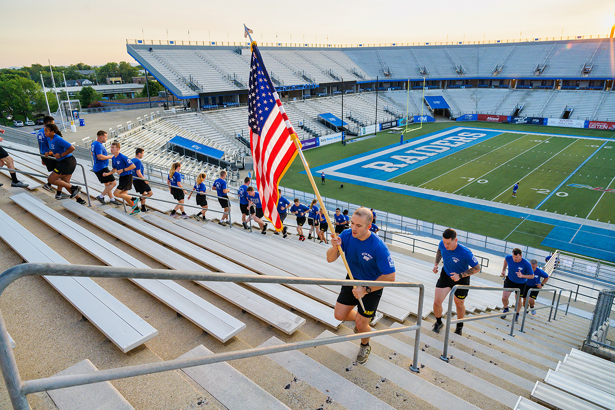 Led by MTSU ROTC cadet flag bearer Joshua Muller, cadet Michael Maynard, Military Science Department leader Carrick McCarthy, Maj. Ben Sweeney and the other cadets and faculty run the steps in Floyd Stadium Friday, Sept. 10, in remembrance of fallen 9/11 first responders who died Sept. 11, 2001. Maynard led the cadet corps in a series of early-morning activities to commemorate the 20th anniversary of the tradegy. (MTSU photo by Andy Heidt)
