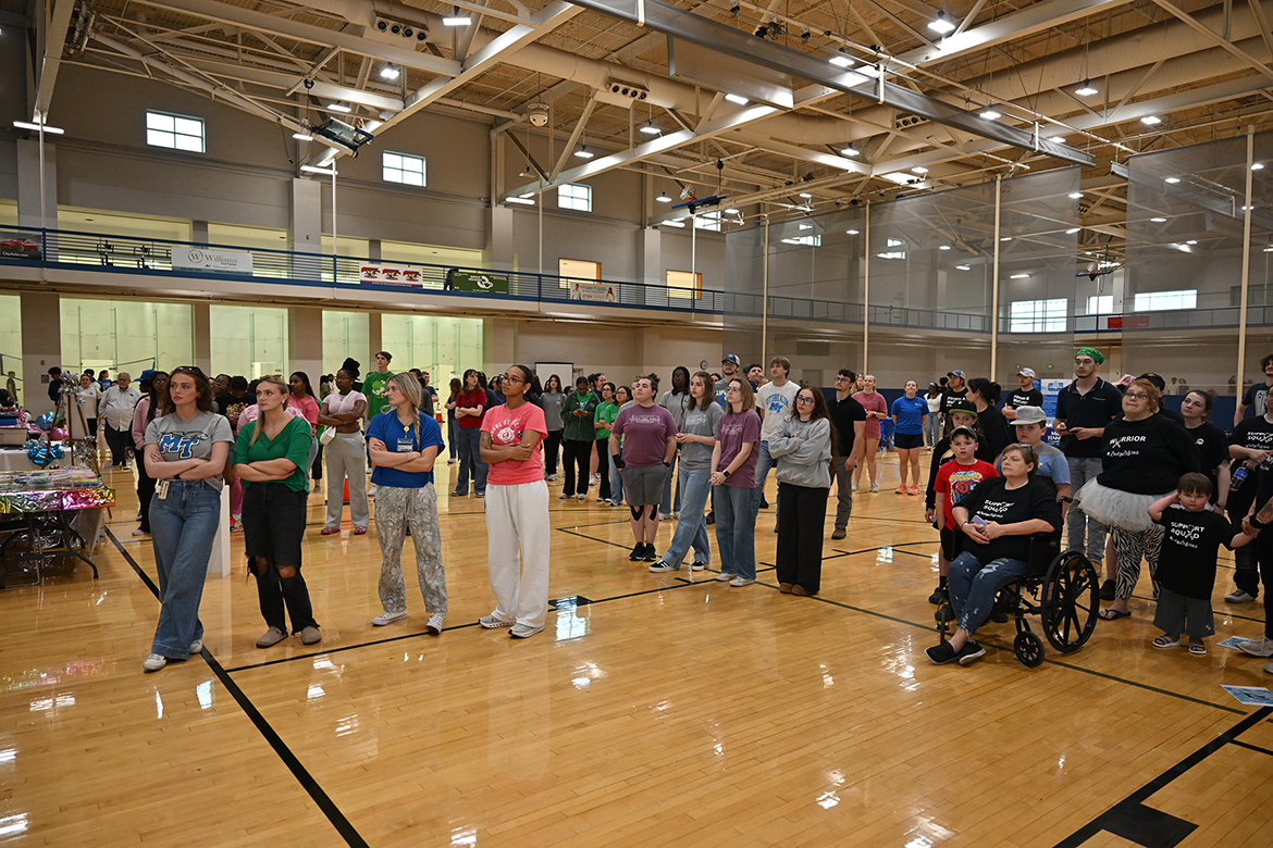 Student and community volunteers listen to speakers during opening ceremonies for the annual Middle Tennessee State University Relay for Life on Friday, March 28 in the Campus Recreation Center gym on the MTSU campus in Murfreesboro, Tenn. About 150 people turned out for the event that featured four hours of games, fundraising walks, special luminaria event and more. (MTSU photo by James Cessna)