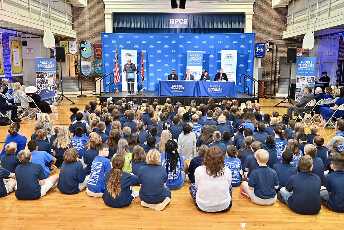Middle Tennessee State University and SCORE (State Collaborative on Reforming Education) signed an agreement Wednesday, Aug. 28, that seeks to improve teacher training within the university’s College of Education. The signing was held in the gymnasium at Homer Pittard Campus School, a K-5 teaching laboratory school owned by MTSU and operated by Rutherford County Schools. In the background are some of the dozens of students that attended the signing. (MTSU photo by J. Intintoli)