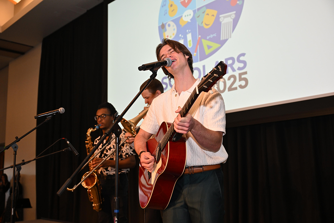 On guitar, frontman Cade Ortego, right, and the band, Cade Ortego and the Mood Swings, perform on stage Friday, March 21, during the annual Middle Tennessee State University Scholars Day wrap-up event in the Student Union Ballroom on the campus in Murfreesboro, Tenn., during lunch. (MTSU photo by James Cessna)