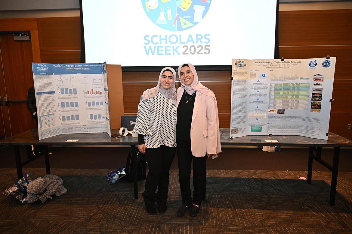 Aya Abdouni, right, Middle Tennessee State University student who has been conducting genetic barcoding of darters (small fish) in Middle Tennessee, attends the annual universitywide Scholars Day event with fellow researcher Malak Abdelraham, whose poster is on the left, in the Student Union Ballroom on the campus in Murfreesboro, Tenn. (MTSU photo by James Cessna)