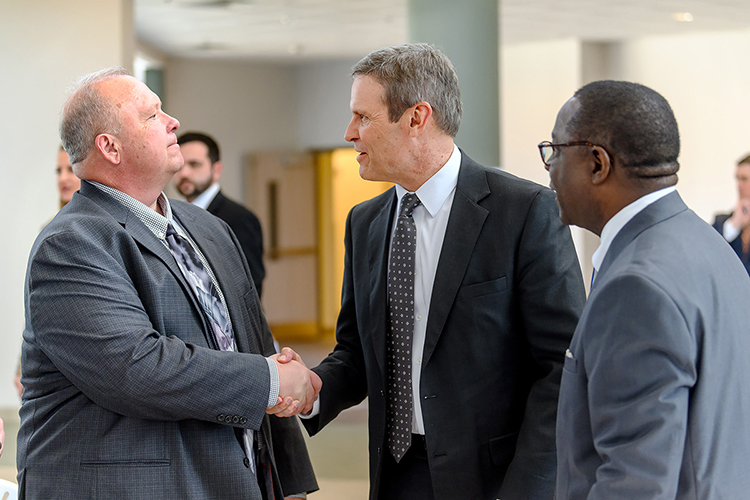 MTSU College of Basic and Applied Sciences Dean Bud Fischer, left, shakes hands with Tennessee Gov. Bill Lee as they meet for the first time while MTSU President Sidney A. McPhee watches. The exchange occurred Wednesday (April 3) at the Miller Education Center as MTSU recognized the Siemens company for its generous grant of computer-aided design software for the mechatronics engineering program. (MTSU photo by J. Intintoli)