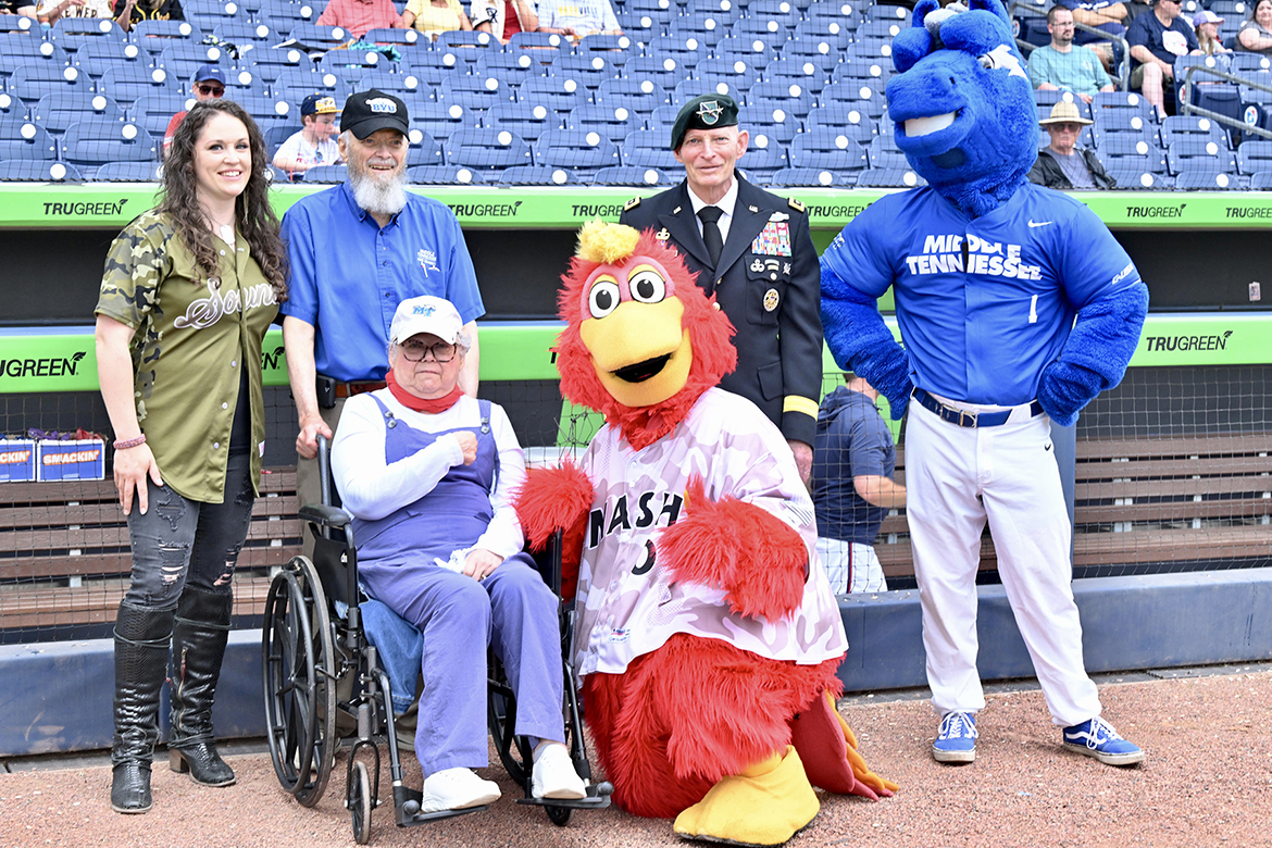 The Nashville Sounds recognized decorated Vietnam-era veteran Horace Stogner of Murfreesboro before the start of the Sunday, May 25, Salute to Armed Forces game at First Horizon Park in Nashville, Tenn. Shown, back row from left, are national anthem singer Rachel Lipsky; Stogner, an Army captain and former MTSU academic advisor; Keith Huber, senior advisor for veterans and leadership initiatives and a retired U.S. Army lieutenant general; and MTSU mascot Lightning; and front row, from left, Catherine Stogner, retired Middle Tennessee State University human sciences associate professor, and Sounds’ mascot Brewster the Rooster. (MTSU photo by James Cessna)