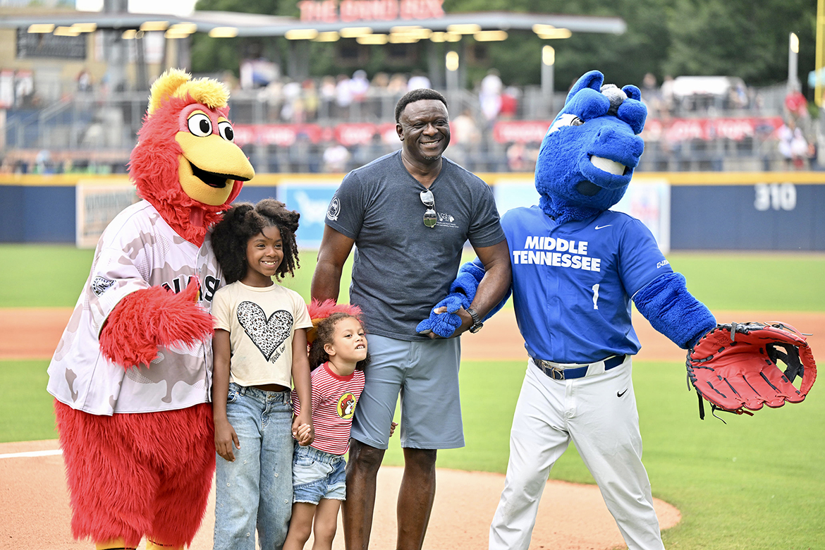 Bennie Thompson, second from right, a recent graduating student veteran from Middle Tennessee State University, prepares to throw out the ceremonial first pitch with assistance from Nashville Sounds’ mascot Nash, left, his granddaughters and MTSU mascot Lightning, Sunday, May 25, at First Horizon Park in Nashville, Tenn. The MTSU True Blue Day and Sounds' Salute to Armed Forces game was rained out after 1½ innings. (MTSU photo by James Cessna)