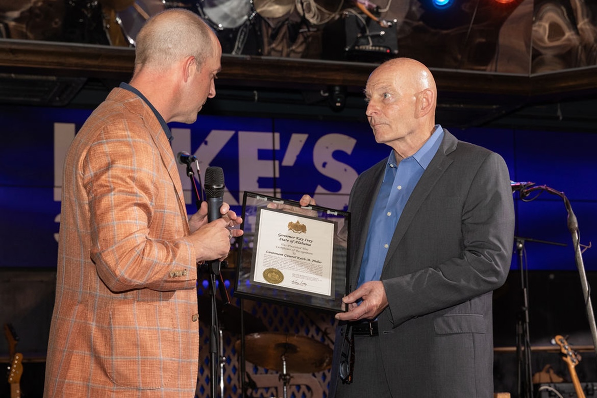 On behalf of Alabama Gov. Kay Ivey, Brandon Dillard, left, Alabama Power senior vice president of resource strategy and stakeholder engagement, presents a certification of recognition and commendation to Keith M. Huber, Middle Tennessee State University senior adviser for veterans and leadership initiatives and retired U.S. Army lieutenant general, earlier this summer in Nashville, Tenn. The certificate of recognition said Huber “exemplifies the highest ideals of leadership, courage and commitment. … Your life’s work is a testament to selfless service and unwavering dedication.” (Photo by Bass Photography)