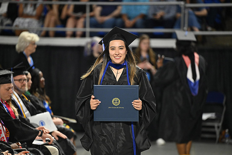A Middle Tennessee State University graduate proudly displays her degree at the spring 2025 afternoon commencement ceremony held Saturday, May 10, inside Murphy Center on the MTSU campus in Murfreesboro, Tenn. (MTSU photo by James Cessna)