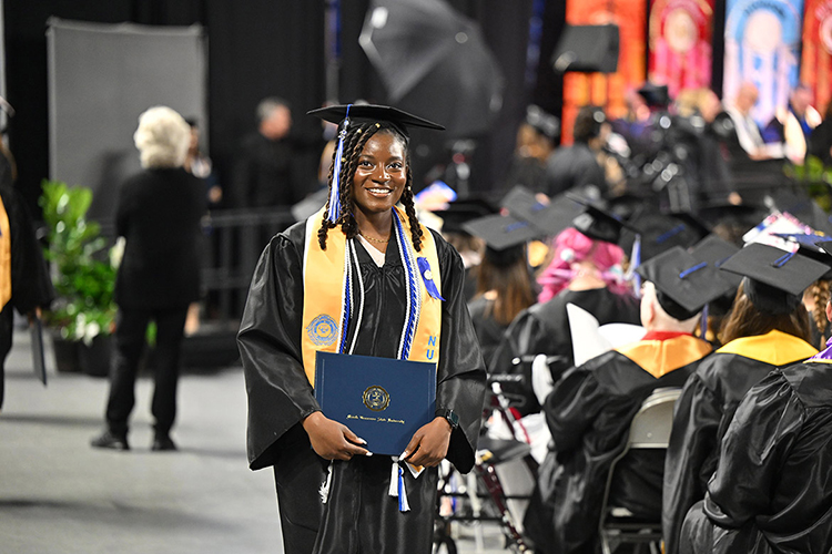 A Middle Tennessee State University graduate returns to her seat after being conferred her degree at the spring 2025 afternoon commencement ceremony held Saturday, May 10, inside Murphy Center on the MTSU campus in Murfreesboro, Tenn. (MTSU photo by James Cessna)