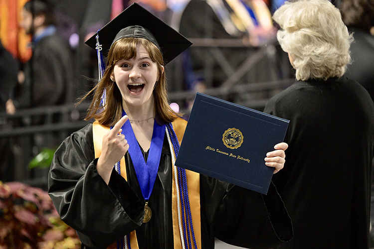 A proud graduate of Middle Tennessee State University shows off her degree during the spring 2025 afternoon commencement ceremony held Saturday, May 10, inside Murphy Center on the MTSU campus in Murfreesboro, Tenn. (MTSU photo by Andy Heidt)