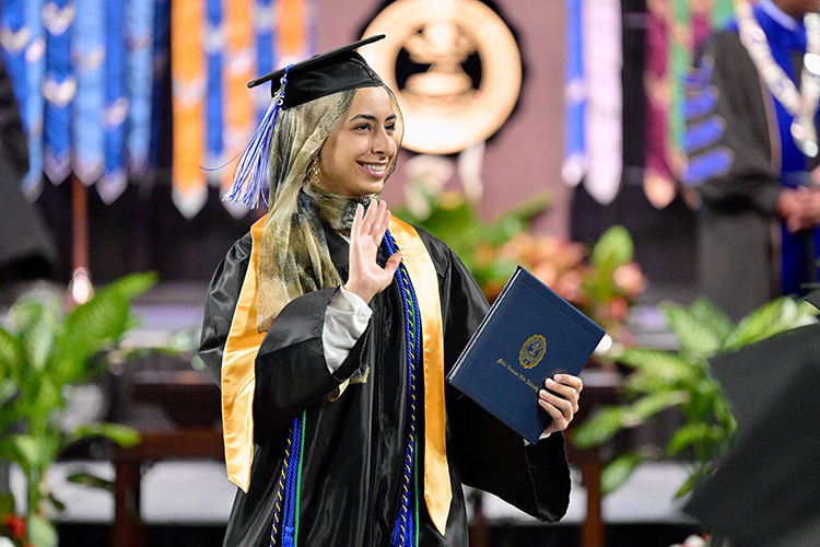 A Middle Tennessee State University graduate proudly waves to a supporter after receiving her degree at the spring 2025 afternoon commencement ceremony held Saturday, May 10, inside Murphy Center on the MTSU campus in Murfreesboro, Tenn. (MTSU photo by Andy Heidt)