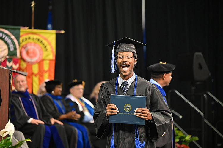 A Middle Tennessee State University graduate proudly displays his degree at the spring 2025 afternoon commencement ceremony held Saturday, May 10, inside Murphy Center on the MTSU campus in Murfreesboro, Tenn. (MTSU photo by James Cessna)