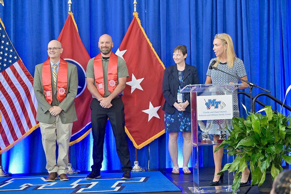 Ross List, left, and Virgil Teter, both from Murfreesboro, Tenn., are both presented the Veterans Leadership Award from the Charlie and Hazel Daniels Veterans and Military Family Center during Middle Tennessee State University’s summer Graduating Veterans Stole Ceremony held Thursday, Aug. 7, in the Miller Education Center’s second-floor atrium on Bell Street. Presenting the award is Dr. Laurie Witherow, second from right, vice provost for enrollment management, and announced by Dr. Hilary Miller, Daniels Center director. (MTSU photo by Andy Heidt)