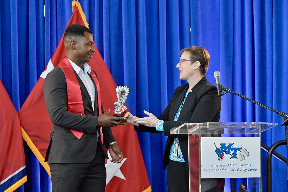 Rashieq Cockerham, left, of Murfreesboro, Tenn., a Middle Tennessee State University graduating senior, receives the Veterans Leadership Award from Laurie Witherow, MTSU vice provost for Enrollment Management, Thursday, May 8, during the Graduating Veterans Stole Ceremony at the Miller Education Center on Bell Street in Murfreesboro, Tenn. A former Marine, Cockerham has been heavily involved in undergraduate research while at MTSU. (MTSU photo by Andy Heidt)