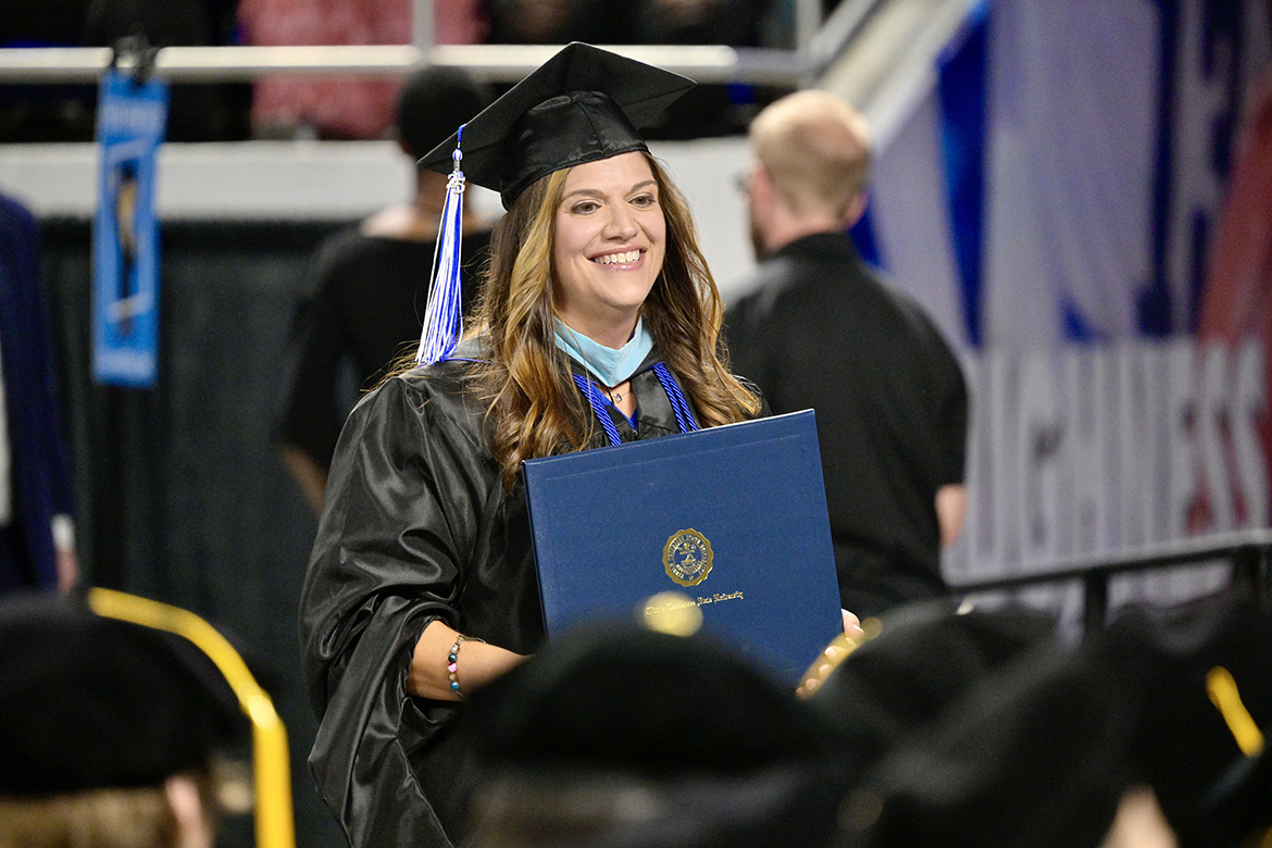 Beth Dye, assistant director in the Alumni Relations Office at Middle Tennessee State University, is all smiles as she holds the master’s degree she received during the summer 2025 commencement ceremony held Saturday, Aug. 9, inside Murphy Center on campus in Murfreesboro, Tenn. (MTSU photo by Andy Heidt)