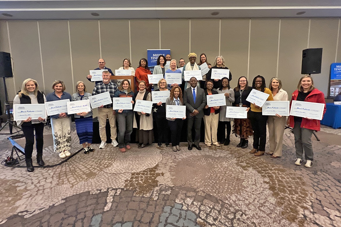 Alabama and southern Middle Tennessee counselors attending the recent Middle Tennessee State University True Blue Tour recruiting event at the Westin Hotel in Huntsville, Ala, pose with MTSU President Sidney A. McPhee, front row center, after they received scholarships to award to their students who are interested in attending the Murfreesboro, Tenn., university. (MTSU photo by Andrew Oppmann)