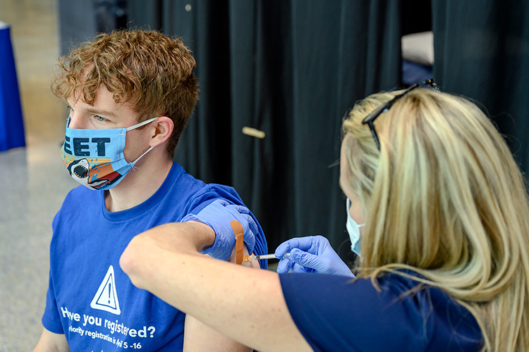 In this April file photo, MTSU student Brett Bingham, left, is vaccinated by nurse practitioner Lady Hamilton during a special clinic inside the Student Union building. MTSU Student Health Services continues offering clinics this summer during CUSTOMS new student orientation sessions and the university is among hundreds nationwide participating in the White House’s COVID College Challenge campaign to increase the nationwide vaccination rate to 70%. (MTSU file photo by J. Intintoli)